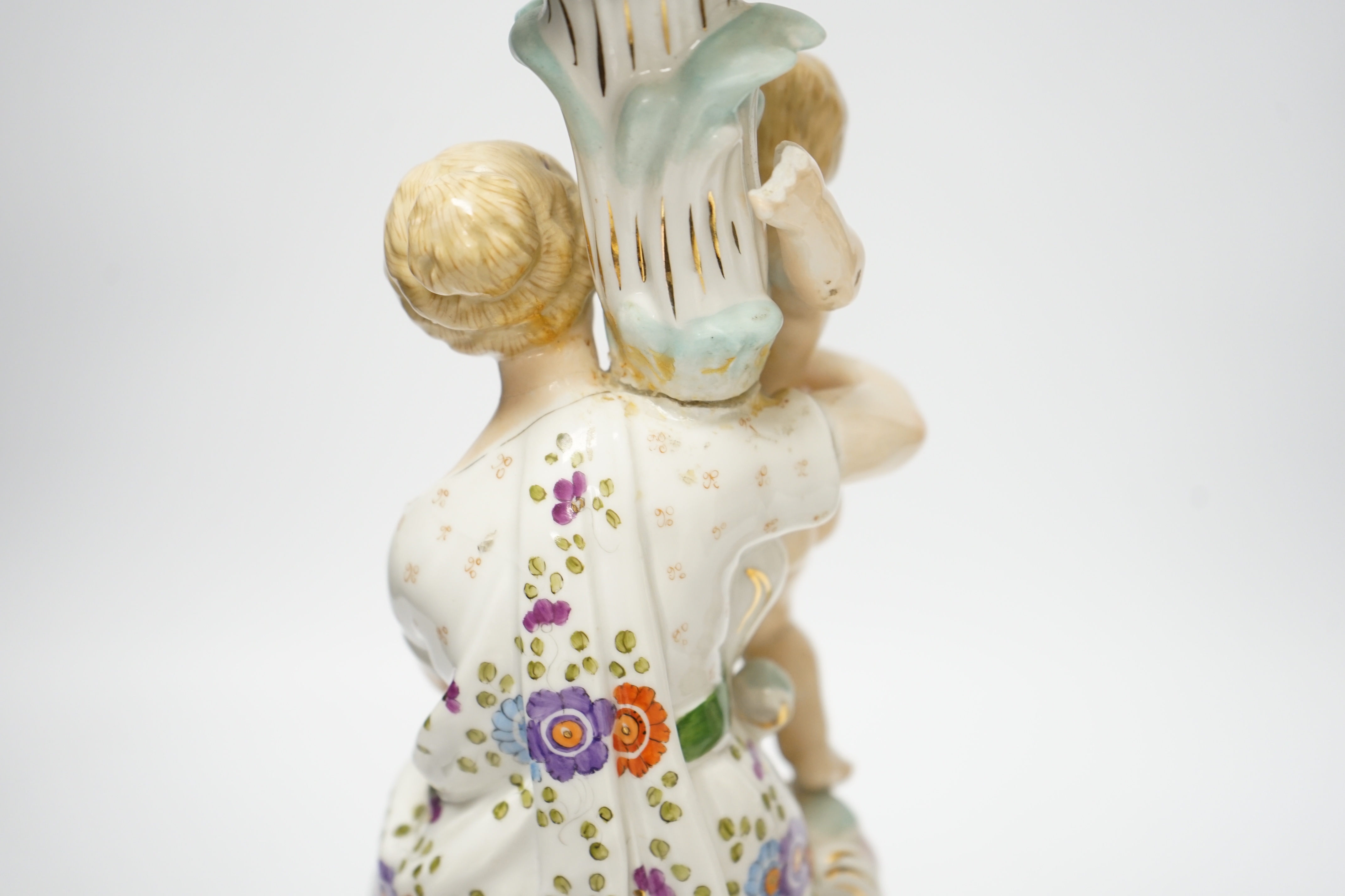 A pair of German floral encrusted porcelain candlesticks of a mother and child group, 38cm high